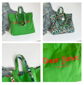 Close-up of double-sided canvas tote bag featuring green base and leaf floral print