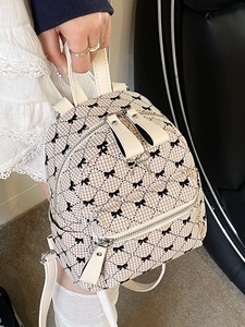 Mini beige plaid backpack with black bow prints and silver metal bow charm detail