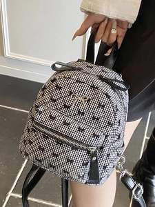 Mini black and white checkered backpack with bow patterns and silver metal bow ornament