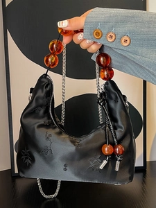 Elegant black satin handbag with plum blossom embroidery and amber bead handle