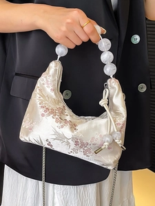 Champagne satin handbag with cherry blossom embroidery and large white acrylic bead handle