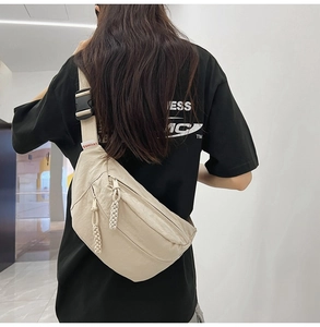 Dettaglio borsa a tracolla in nylon beige con doppia zip e fibbia regolabile