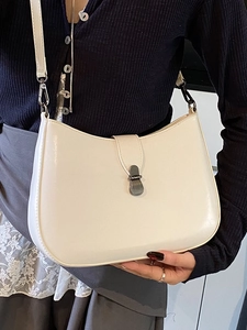Minimalist cream white underarm bag with vintage metal clasp and slim shoulder strap