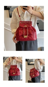 Detail of red quilted leather backpack with gold chain straps and metal twist lock