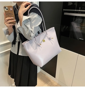 Close-up of light purple oil wax leather tote bag with elegant gold square metal detail