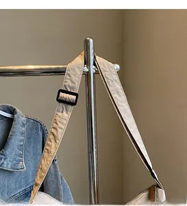 Adjustable beige nylon shoulder strap with black buckle detail on a casual tote bag