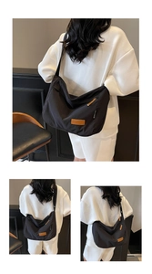 Detailed views of a black nylon crossbody tote bag with a branded leather patch and strap