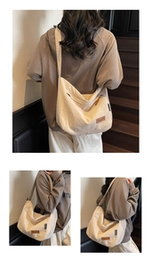 Detailed view of the off-white canvas tote bag featuring a leather logo and side zipper pocket