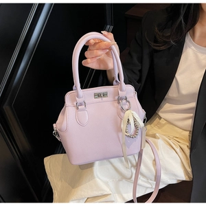 Detail of lavender lychee grain handbag with silver clasp and elegant ribbon pendant