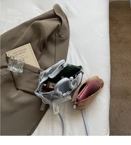 Spacious interior of light blue pleated bucket bag showing capacity for phone and perfume