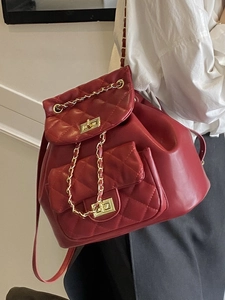 Chic burgundy quilted backpack with gold chain straps and turn-lock closure detail