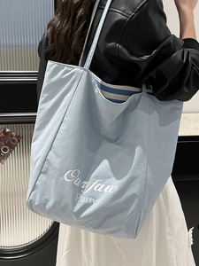 Light blue nylon tote bag with Ourfave Party print and striped shoulder straps