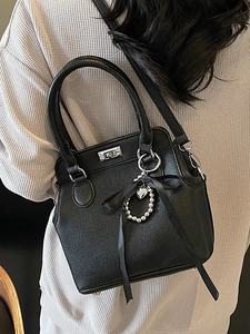 Elegant black lychee pattern Kelly bag with silver lock and heart charm for women