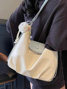 Sac hobo minimaliste blanc crème avec poche bleu clair et charmants accessoires suspendus