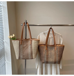 Detail view of woven straw tote bags with hollow mesh design and leather shoulder straps
