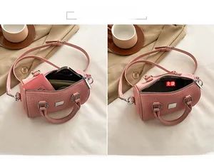 Detail view of pink tweed pillow bag interior showing main compartment for essentials