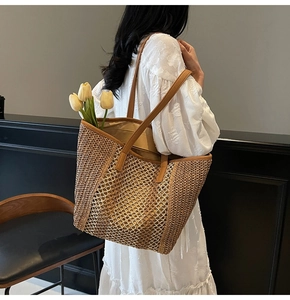 Detail of woven straw tote bag with diamond patterns worn by a woman in white dress