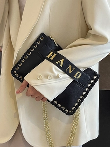 Chic black woven envelope bag with gold chain strap and HAND metallic lettering