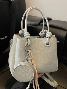 Chic mint green lychee pattern bucket bag with a knotted handle and woven strap decor