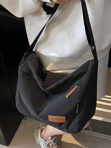 Minimalist large capacity black crossbody tote bag with adjustable strap and leather logo