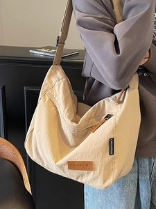 Minimalist beige oversized nylon tote bag with adjustable shoulder strap for women
