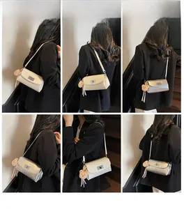 Detail shots of the sleek oil wax leather pillow bag with a plush bear charm pendant