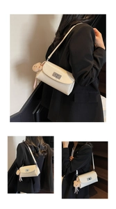 Detail of off-white pillow bag featuring a silver twist lock and cute bear charm