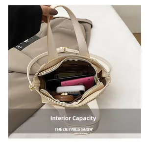 Detailed top view of beige bucket bag interior showing multiple storage compartments