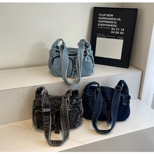 Three multi-pocket denim crossbody bags in light blue, charcoal and navy blue colors