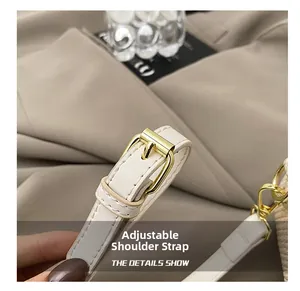 Detail view of off-white PU leather strap with adjustable golden buckle and fine stitching