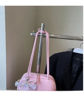 Pink underarm pillow bag featuring pearl and lace bow charms with double handles