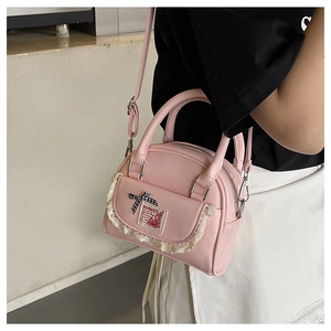 Detail of pink PU Boston bag with lace trim, checkered bows and fantasy rabbit patch