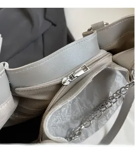 Close-up of silver metal zipper and grey herringbone fabric lining on wave tote bag