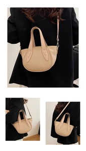 Detail of woven crescent bucket bag with leather strap and golden metal hardware