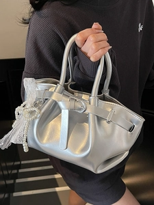 Metallic silver pleated bucket bag with pearl lace charm and decorative buckle detail