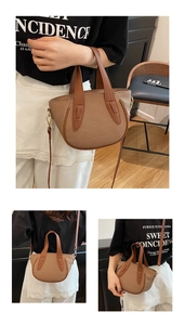 Detail showing brown woven bucket bag with leather handles and gold metal hardware