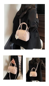 Detail of pink pillow bag with lychee texture, fashion text, and pearl heart charm