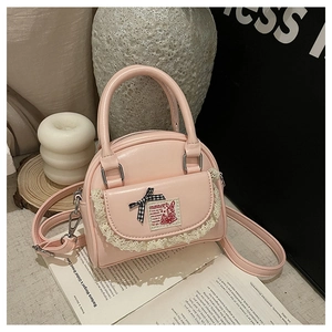 Detail of pink mini Boston bag with lace pocket, ribbon bow and rabbit embroidery