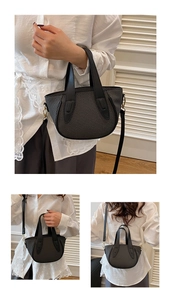 Detail view of woven bucket bag with leather trim and detachable shoulder strap