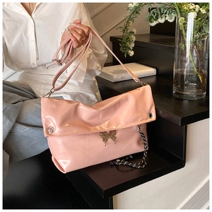 Sac rose brillant en similicuir avec boucle papillon et cordon sur un escalier sombre