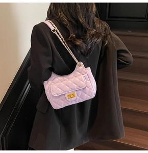 Detailed view of lavender quilted crossbody bag with gold chain and turn-lock closure