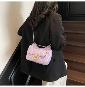 Detail of lavender quilted chain bag featuring golden twist lock and luxury texture