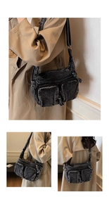 Detailed macro view of vintage washed black denim texture and zipper pockets on hobo bag