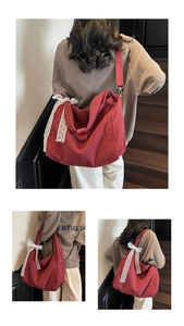 Detail of red plaid canvas bag featuring delicate white lace bow and wide strap