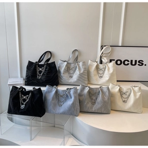 Multiple colors of ripple texture tote bags with butterfly charms on display stands