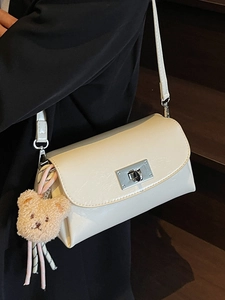 Minimalist beige crossbody bag in oil wax leather with cute bear charm for women