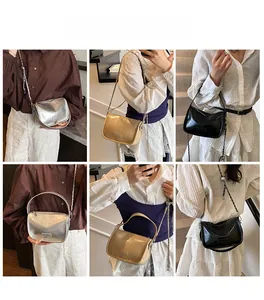 Detailed views of stylish semi-circular crossbody bags in silver, gold, and black with chains