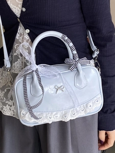 Light blue patent leather ballet style handbag with lace trim and ribbon detail
