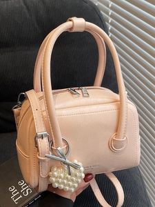 Pink faux leather pillow bag with pearl heart charm and adjustable shoulder strap