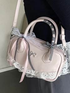 Pink ballet-style Boston bag with lace trim, silver bow, and checkered ribbon handle